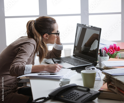 Photo: hard working woman with office files hard working woman with office files