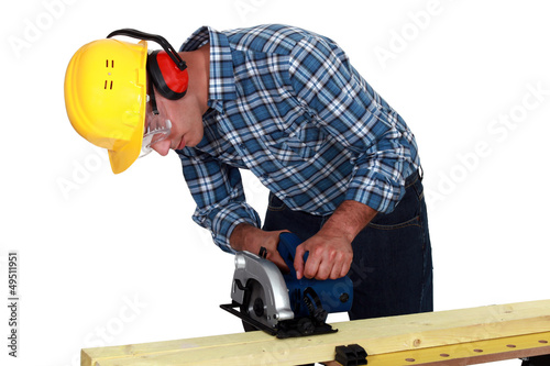 Photo: Carpenter using band saw Carpenter using band saw