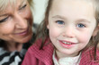 Little girl sitting with her grandmother