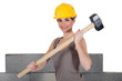 Attractive construction worker holding a mallet