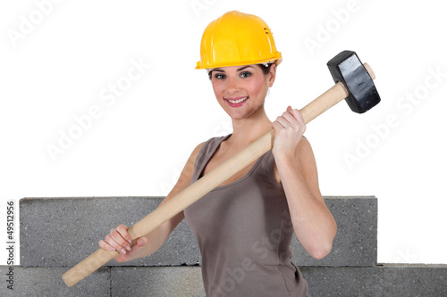Photo: Attractive construction worker holding a mallet Attractive construction worker holding a mallet