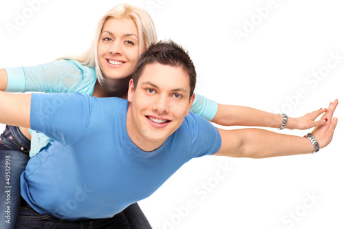 Photo: Young happy couple posing piggyback Young happy couple posing piggyback
