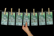 Dirty money hanging from a clothesline isolated on black