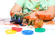 Little boy is playing with paints