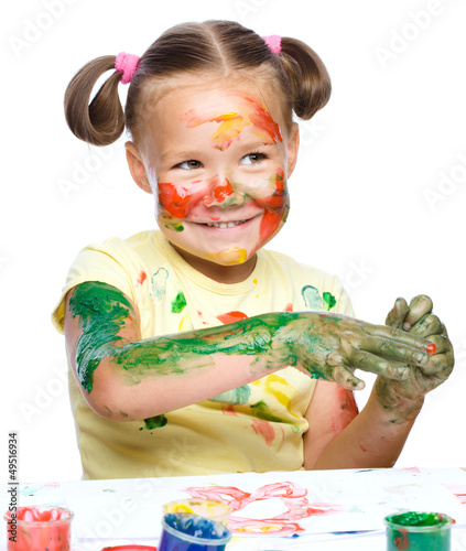 Photo: Portrait of a cute girl playing with paints Portrait of a cute girl playing with paints