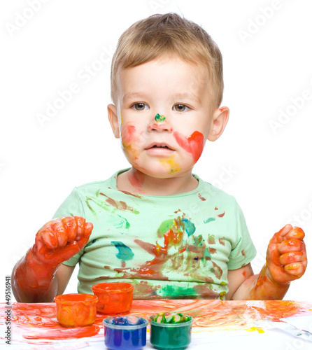 Photo: Little boy is playing with paints Little boy is playing with paints