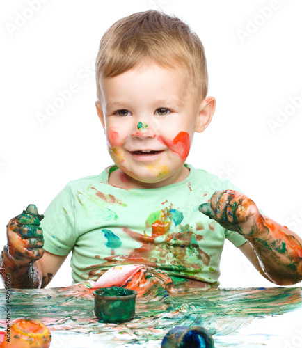 Photo: Little boy is playing with paints Little boy is playing with paints