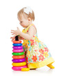 Photo: girl building pyramid on floor on white background girl building pyramid on floor on white background