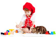 child painting and playing with cat kitten
