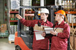warehouse workers in front of forklift