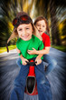 Siblings  on toy racing car