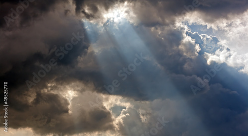 Photo: Sun rays through storm clouds Sun rays through storm clouds