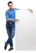 Young man by blank whiteboard