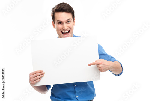 Photo: Young man pointing towards blank sign Young man pointing towards blank sign