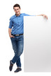 Young man by blank whiteboard