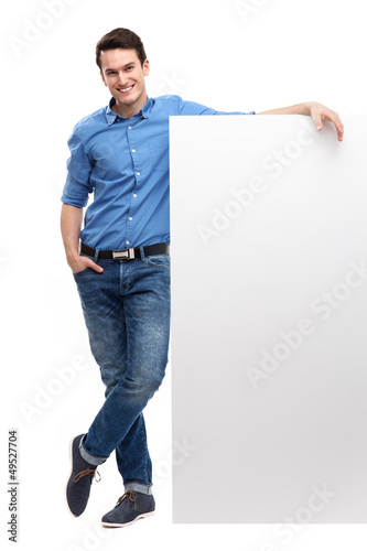 Photo: Young man by blank whiteboard Young man by blank whiteboard