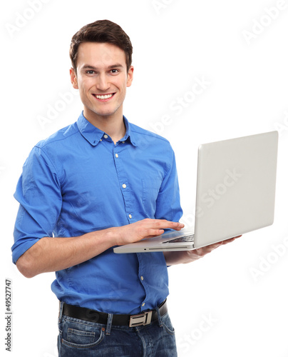 Photo: Portrait of young man holding laptop Portrait of young man holding laptop