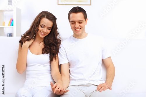 Photo: Young happy couple at hone together s Young happy couple at hone together s