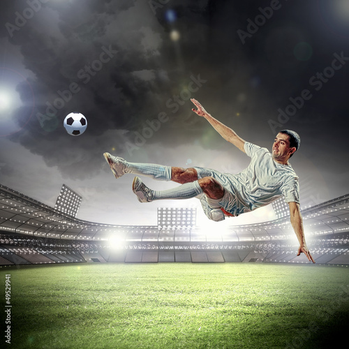 Photo: football player striking the ball football player striking the ball