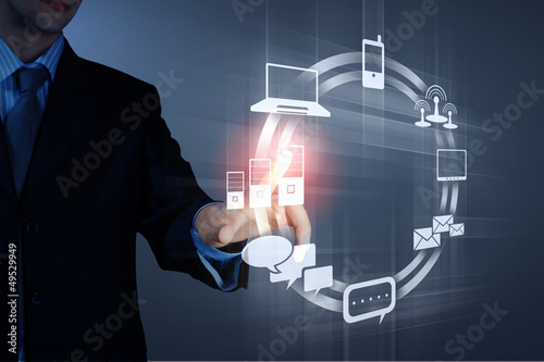 Photo: hand pushing on a touch screen hand pushing on a touch screen