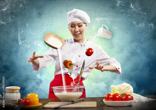 Photo: Asian female cooking with magic Asian female cooking with magic