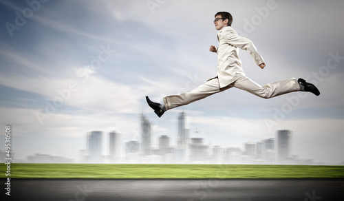 Photo: Businessman running on the road Businessman running on the road