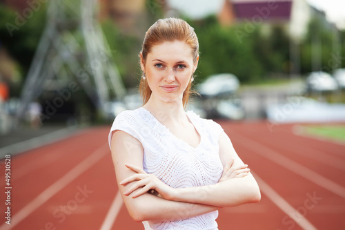 Photo: Business woman at athletic stadium Business woman at athletic stadium