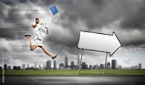 Photo: Businesswoman running on the road Businesswoman running on the road