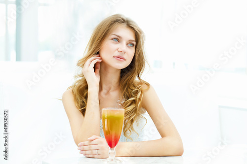 Photo: Young woman with a glass of drink Young woman with a glass of drink