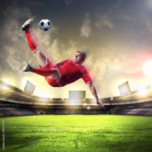 Photo: football player striking the ball football player striking the ball