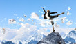 businesswoman standing atop of mountain