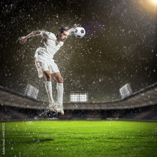 Photo: football player striking the ball football player striking the ball