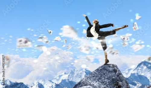 Photo: businesswoman standing atop of mountain businesswoman standing atop of mountain