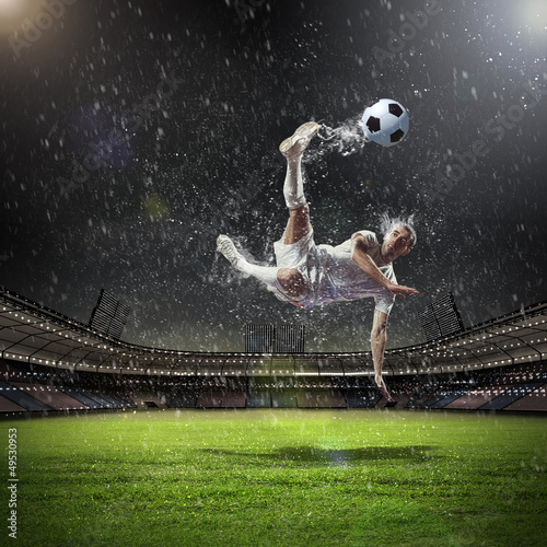 Photo: football player striking the ball football player striking the ball