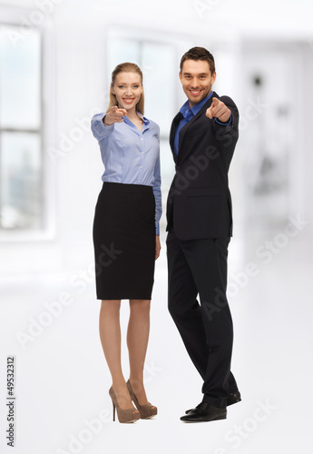 Photo: man and woman pointing their fingers man and woman pointing their fingers