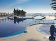 swimming pool with tree, bridges and white umbrella