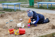 Toddler playing in sandbox
