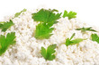 Fresh cottage cheese (curd) heap with parsley, isolated on white