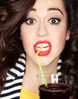 Beautiful brunette woman drinking cocktail