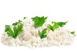 Fresh cottage cheese (curd) heap with parsley, isolated on white