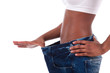 Young african woman in old jeans pant after losing weight