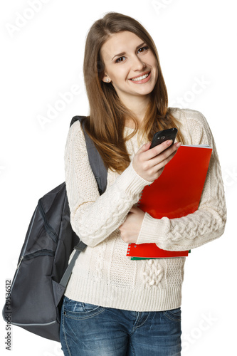 Photo: Woman student with backpack sending sms on cell phone Woman student with backpack sending sms on cell phone