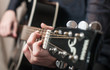 Female hands playing acoustic guitar