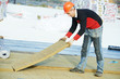 roofer worker installing roof insulation material