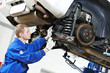 auto mechanic at car suspension repair work