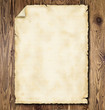 Old grunge paper on wooden planks