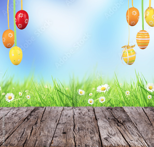 Photo: Easter concept with colored eggs and wooden planks Easter concept with colored eggs and wooden planks