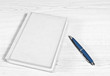 Photo: notepad with pen lying on the desk notepad with pen lying on the desk