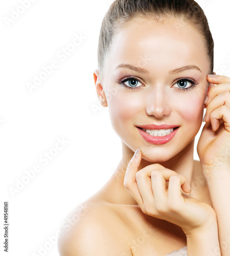 Photo: Beautiful Young Woman with Fresh Clean Skin touching her Face Beautiful Young Woman with Fresh Clean Skin touching her Face