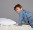 Little boy wearing blue pyjamas in bed